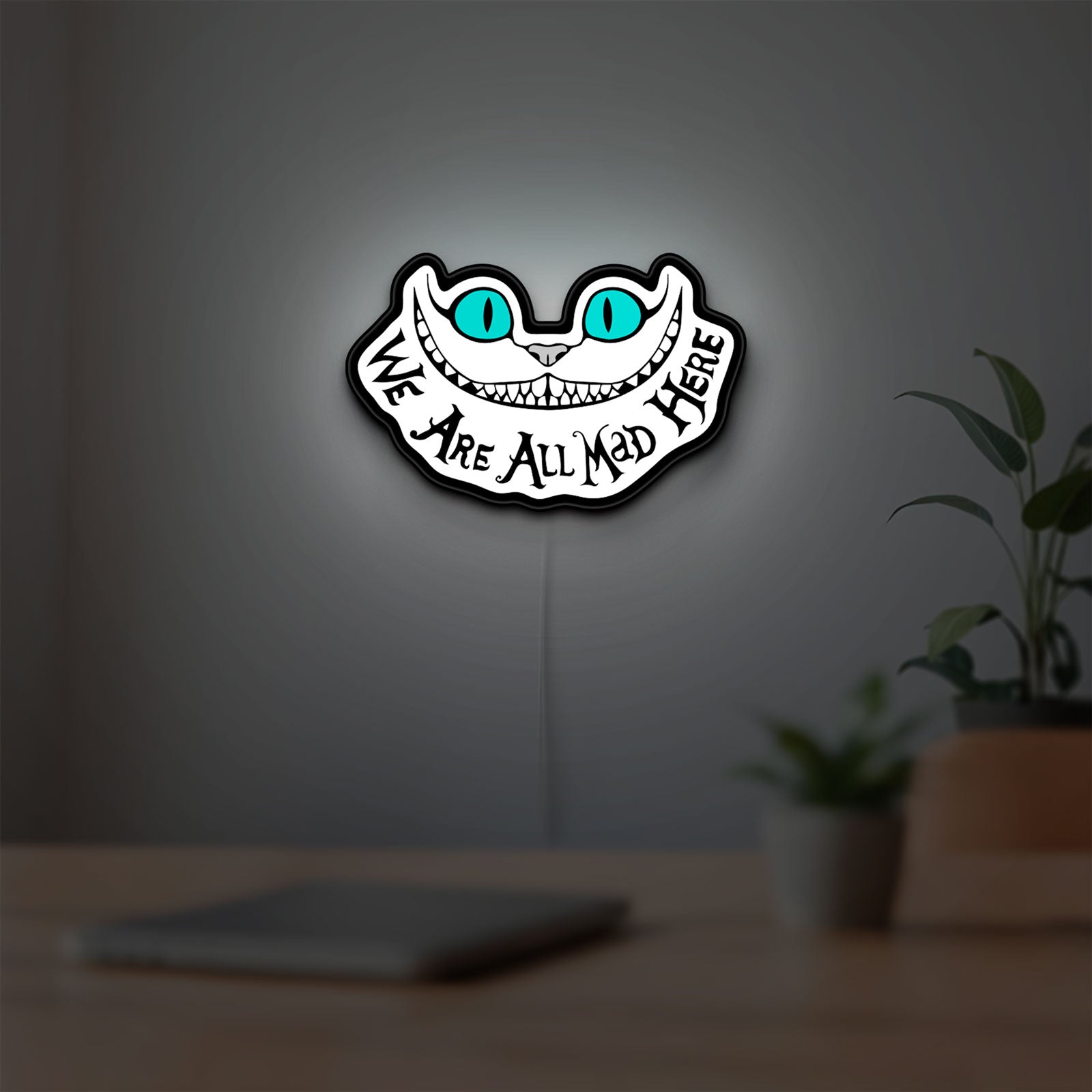 Alice in Wonderland Cheshire Cat LED lightbox hanging on a room wall with soft white light