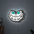 Alice in Wonderland Cheshire Cat LED lightbox hanging on a wall with white glow