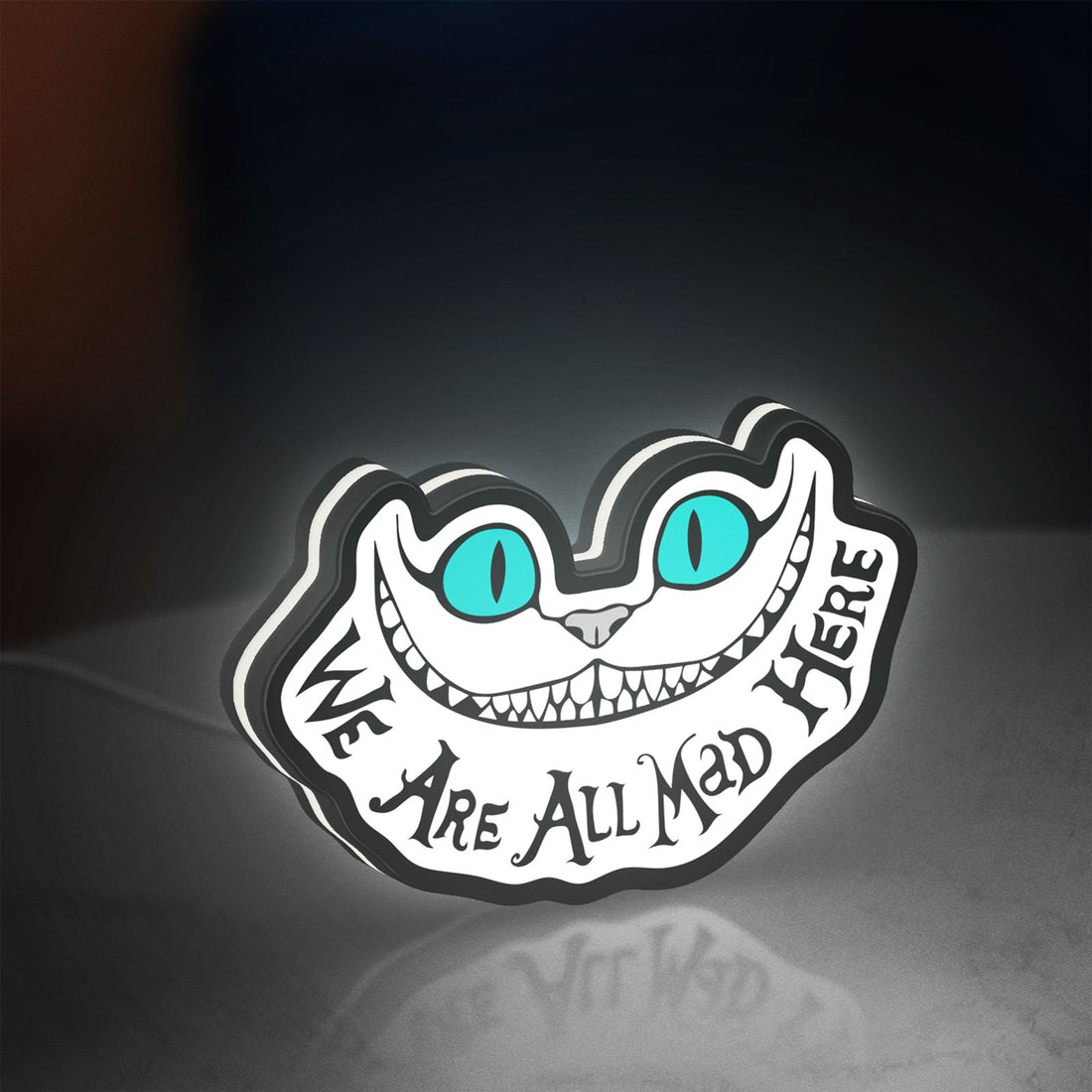 Alice in Wonderland Cheshire Cat LED lightbox hanging on a wall with white glow