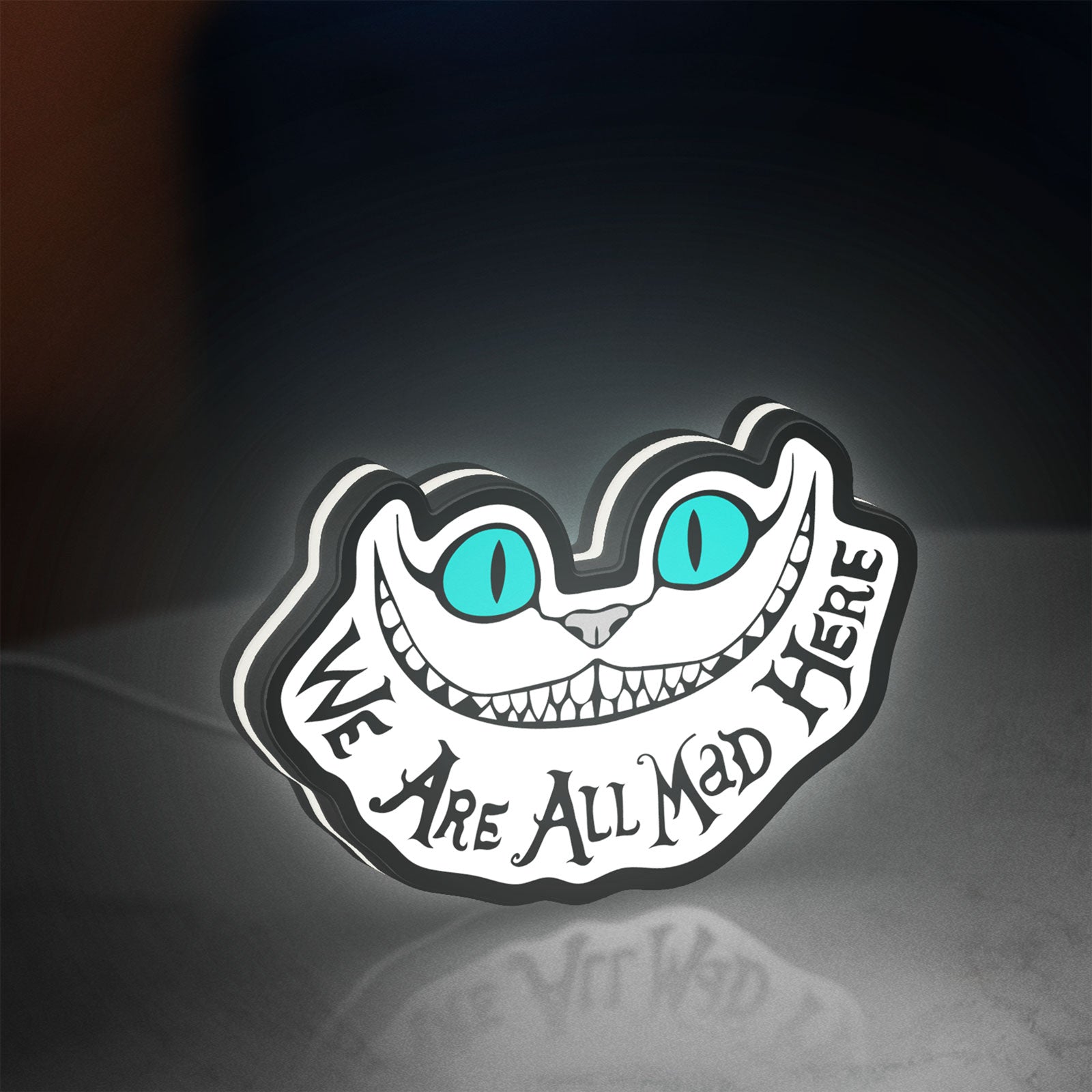 Alice in Wonderland Cheshire Cat LED lightbox standing on a desk from an angled side view with white glow