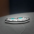 Alice in Wonderland Cheshire Cat LED lightbox lying flat on a desk with white glow