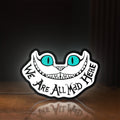 Front view of Alice in Wonderland Cheshire Cat LED lightbox sign glowing on a wooden desk