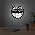 Alice in Wonderland Cheshire Cat LED lightbox hanging on a room wall with soft white light
