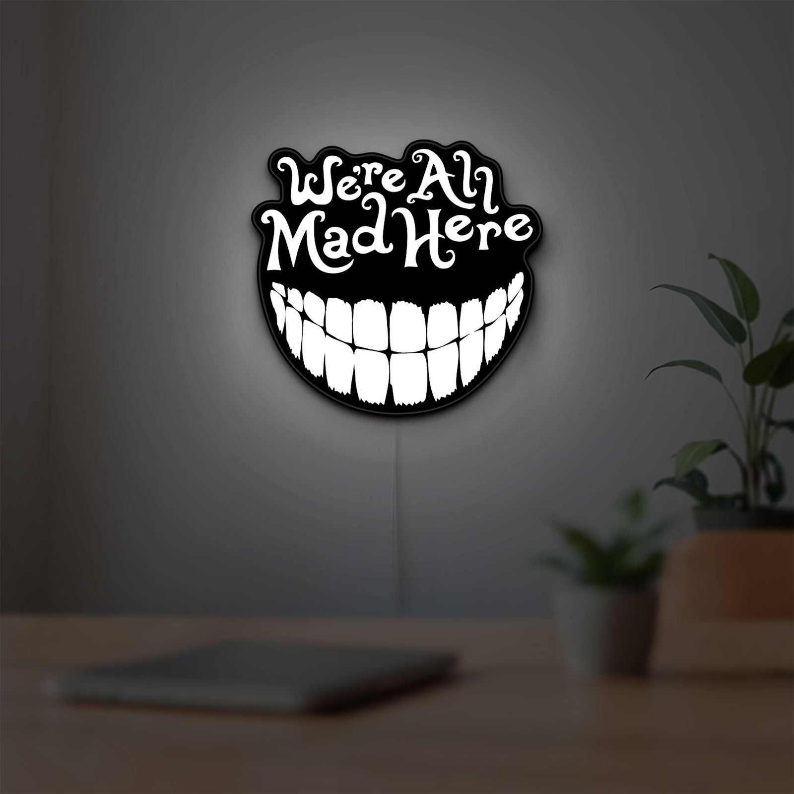 Alice in Wonderland Cheshire Cat LED lightbox hanging on a room wall with soft white light