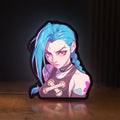 Front view of Arcane Jinx League of Legends LED lightbox sign glowing on a wooden desk