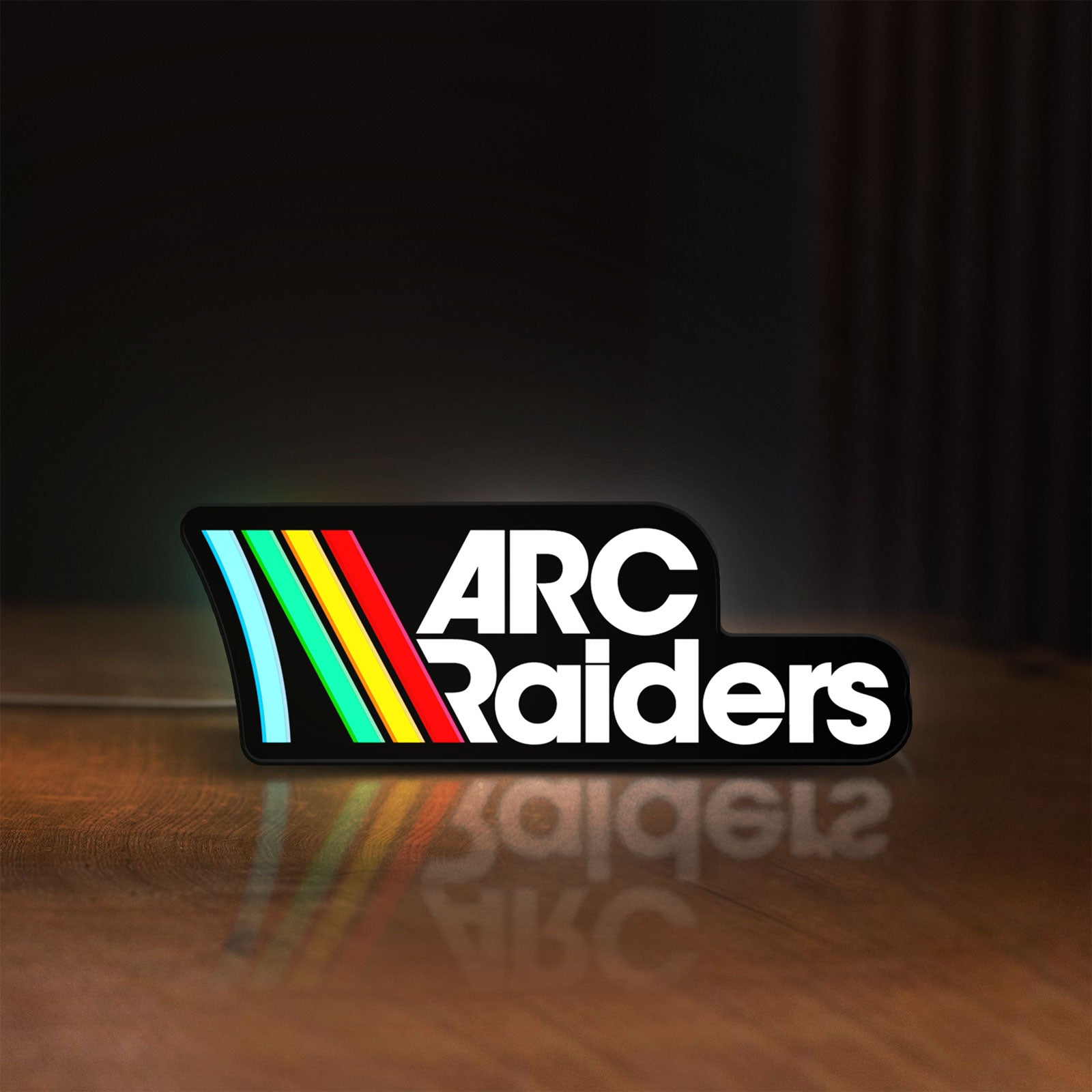 Front view of ARC Raiders Sci-Fi Looter Shooter LED lightbox sign glowing on a wooden desk
