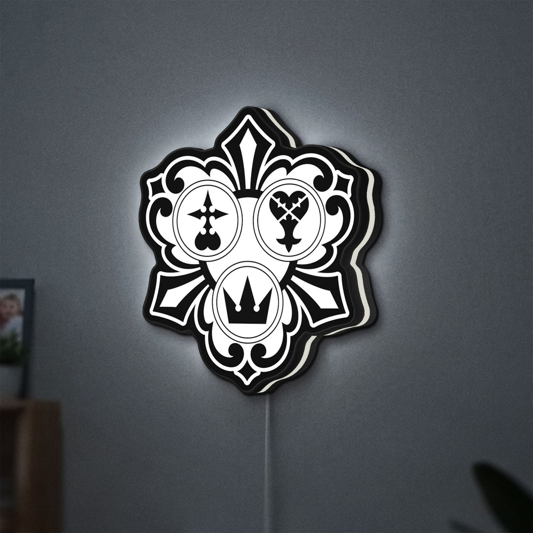 Kingdom Hearts Keyblade Sora Crown LED lightbox hanging on a wall with white glow