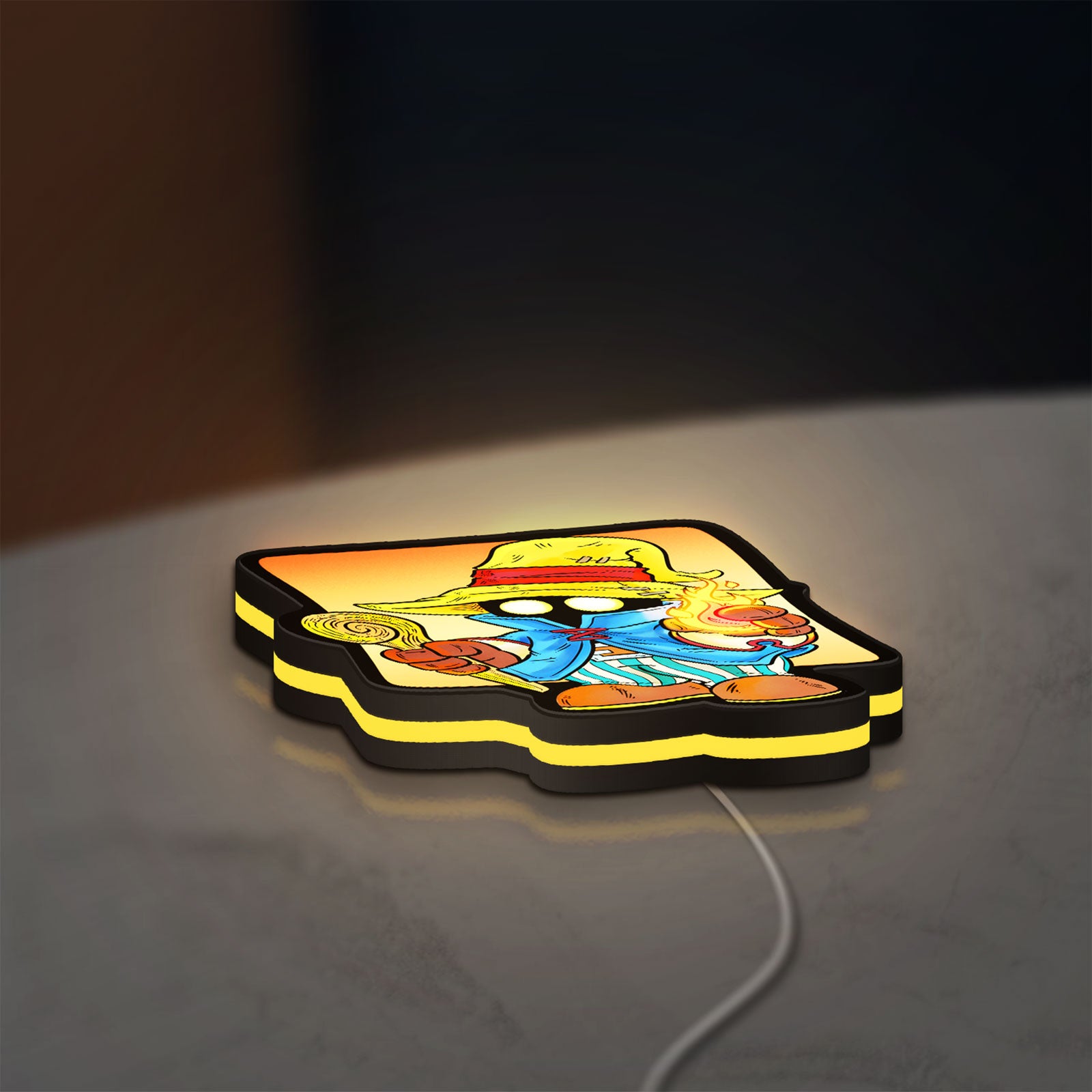 Final Fantasy Black Mage Retro RPG LED lightbox lying flat on a desk with yellow glow