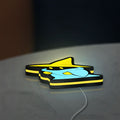 Final Fantasy Black Mage Retro RPG LED lightbox lying flat on a desk with yellow glow