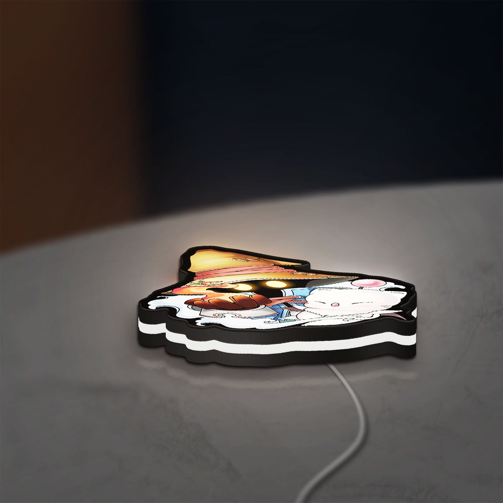 Final Fantasy IX Vivi Ornitier LED lightbox lying flat on a desk with white glow