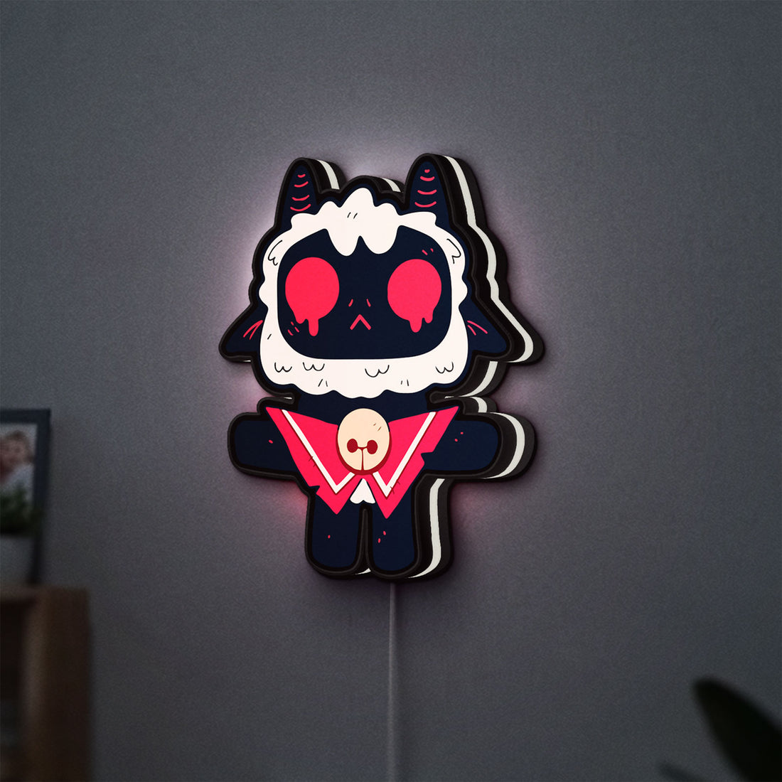 Cult of the Lamb Indie Game LED lightbox hanging on a wall with white glow