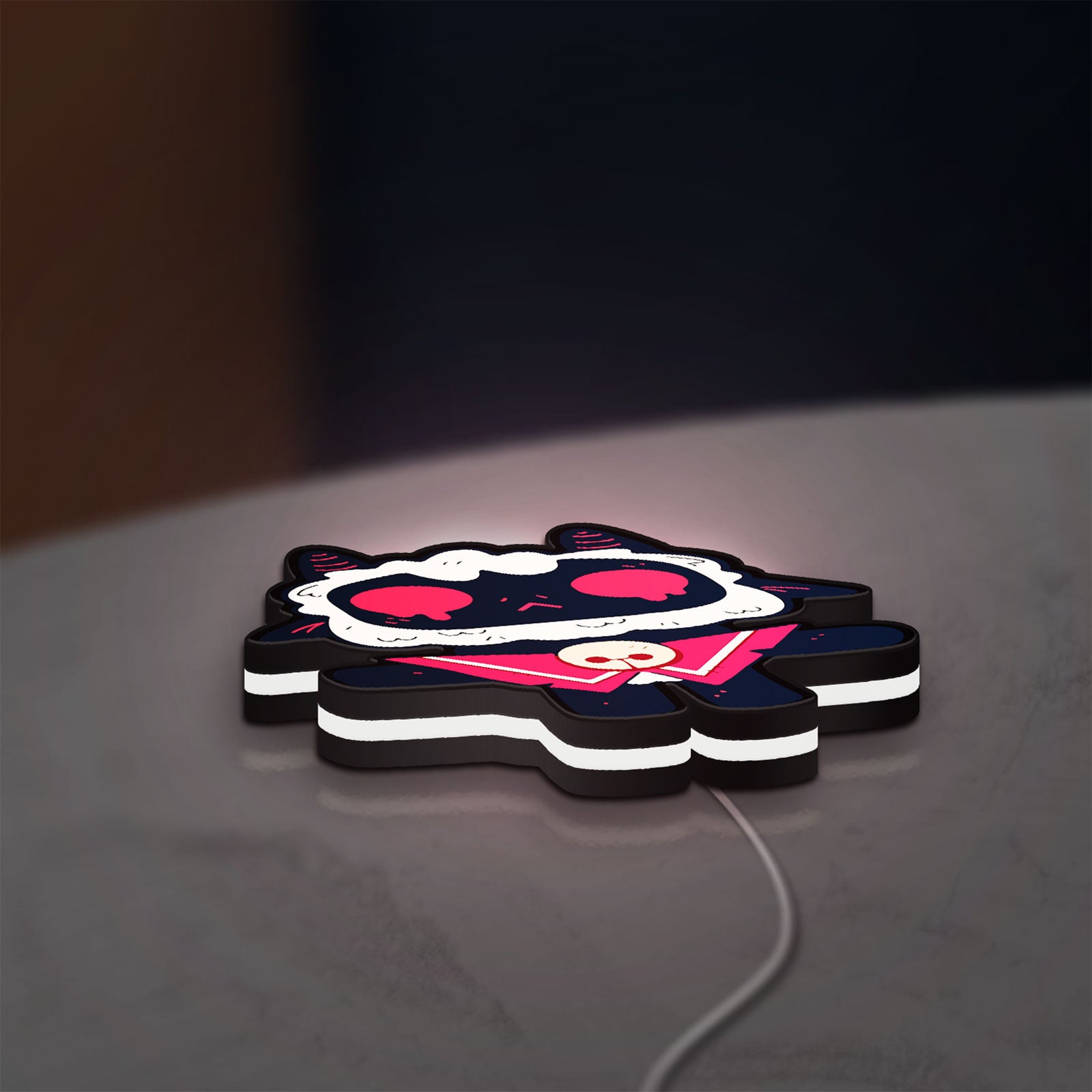 Cult of the Lamb Indie Game LED lightbox lying flat on a desk with white glow