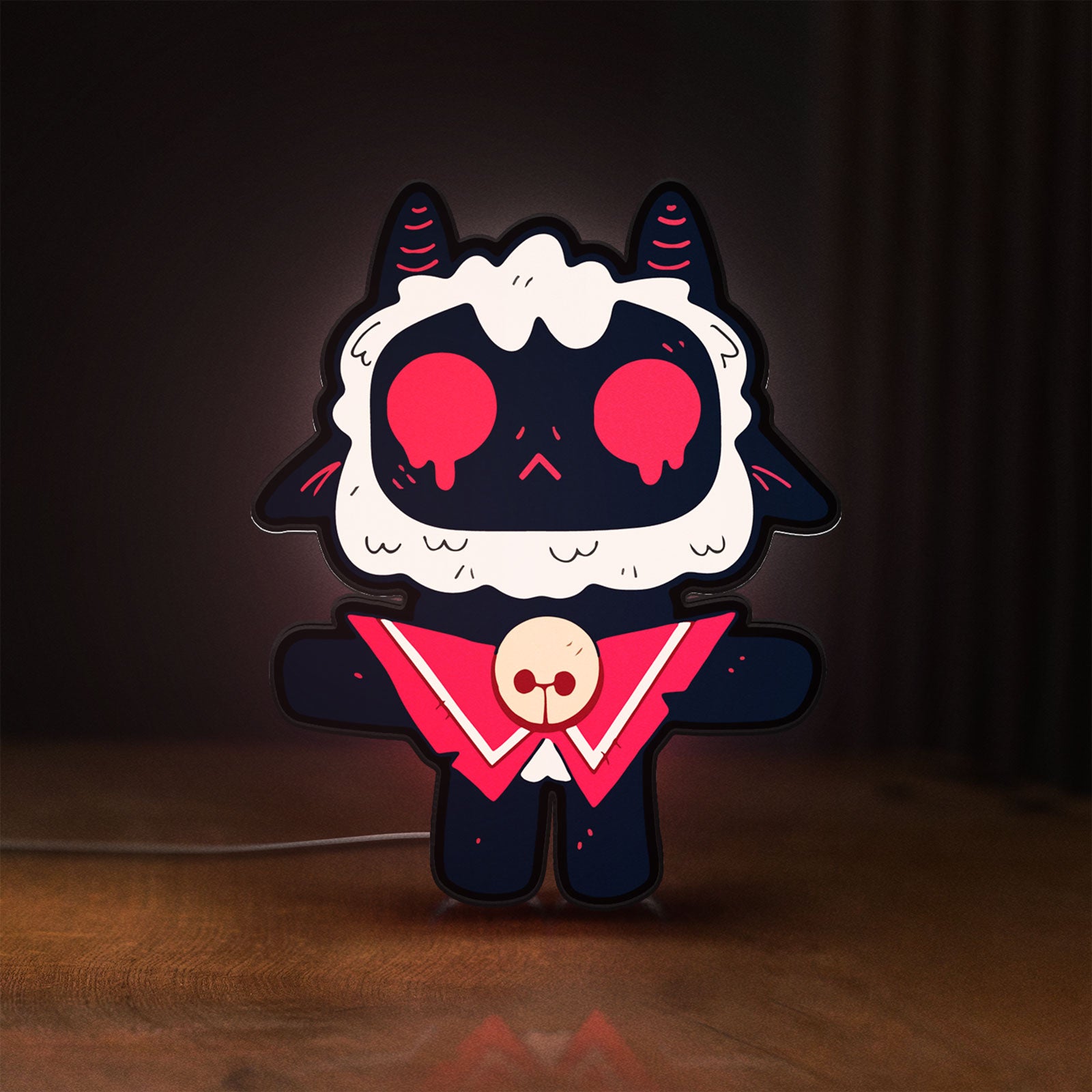 Front view of Cult of the Lamb Indie Game LED lightbox sign glowing on a wooden desk