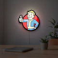 Fallout Vault Boy Thumbs Up Mascot LED lightbox hanging on a room wall with soft red light