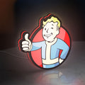 Fallout Vault Boy Thumbs Up Mascot LED lightbox standing on a desk from an angled side view with red glow