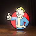 Front view of Fallout Vault Boy Thumbs Up Mascot LED lightbox sign glowing on a wooden desk