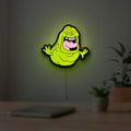 Ghostbusters Slimer 80s Movie LED lightbox hanging on a room wall with soft green light