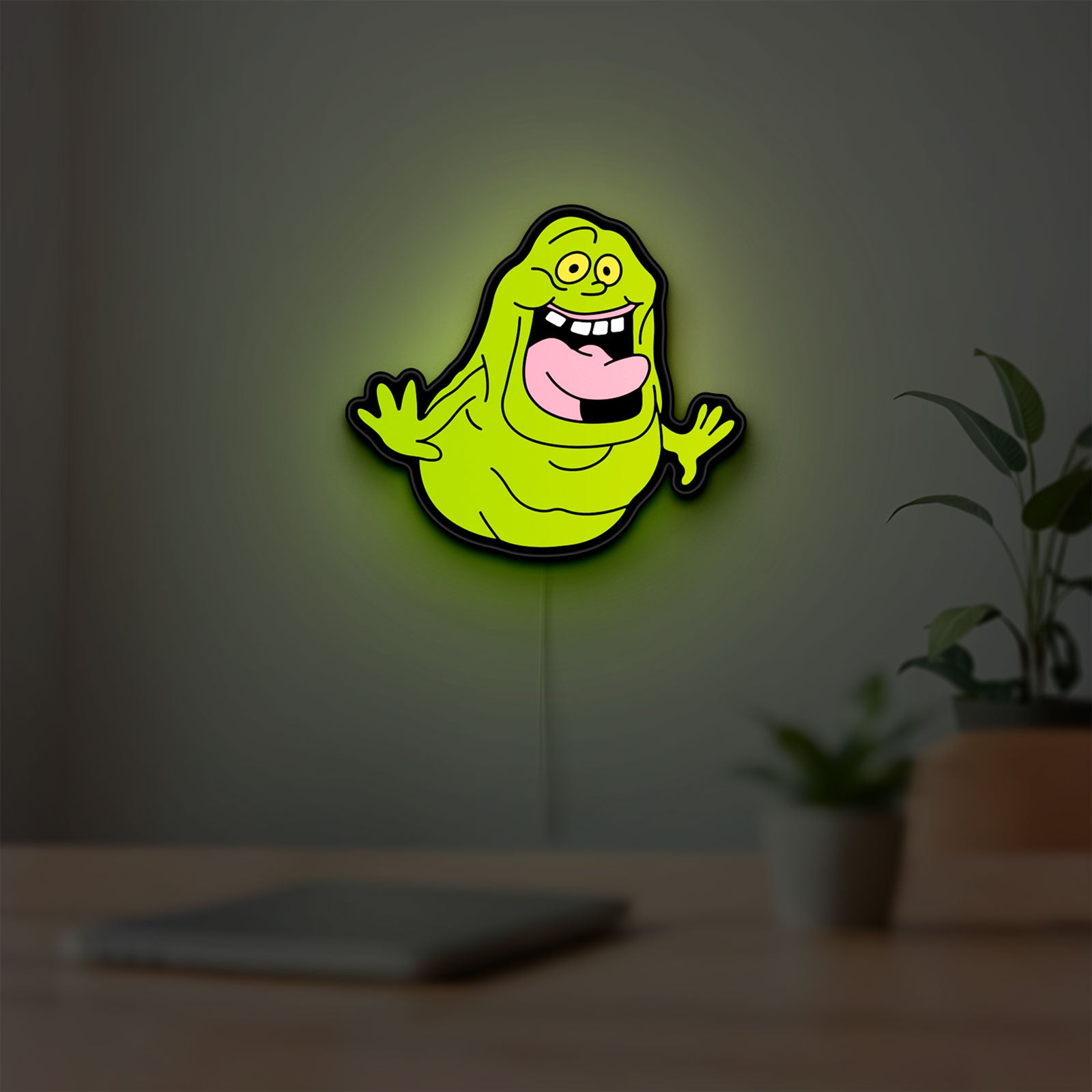 Ghostbusters Slimer 80s Movie LED lightbox hanging on a room wall with soft green light