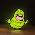 Front view of Ghostbusters Slimer 80s Movie LED lightbox sign glowing on a wooden desk