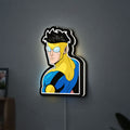 Invincible Title Logo Superhero LED lightbox hanging on a wall with white glow