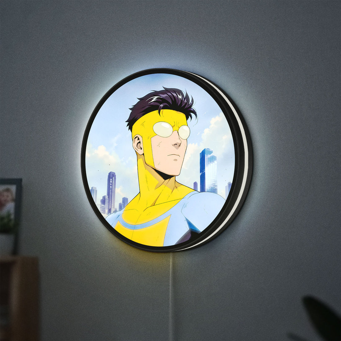 Invincible Title Logo Superhero LED lightbox hanging on a wall with white glow