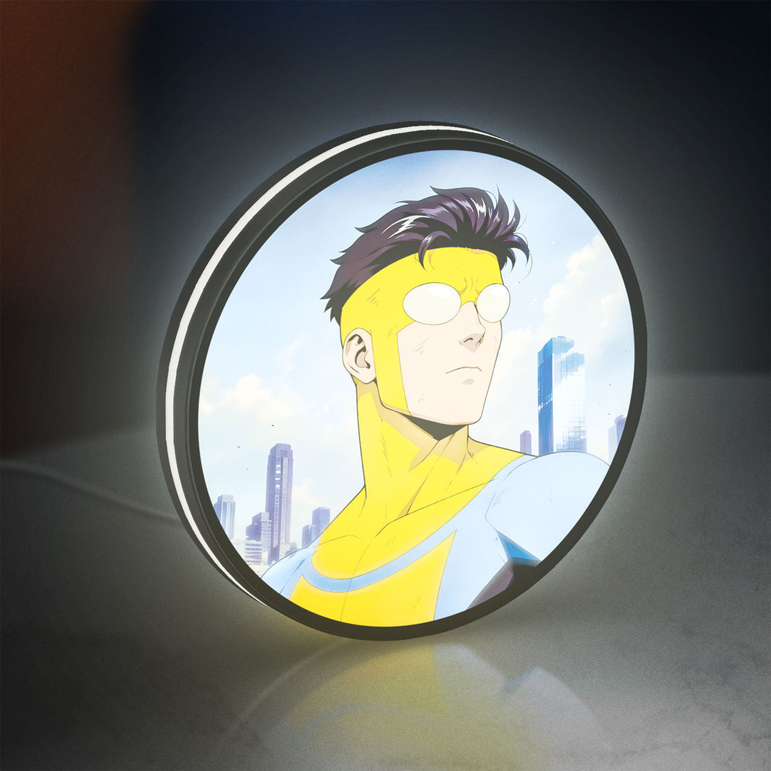 Invincible Title Logo Superhero LED lightbox hanging on a wall with white glow