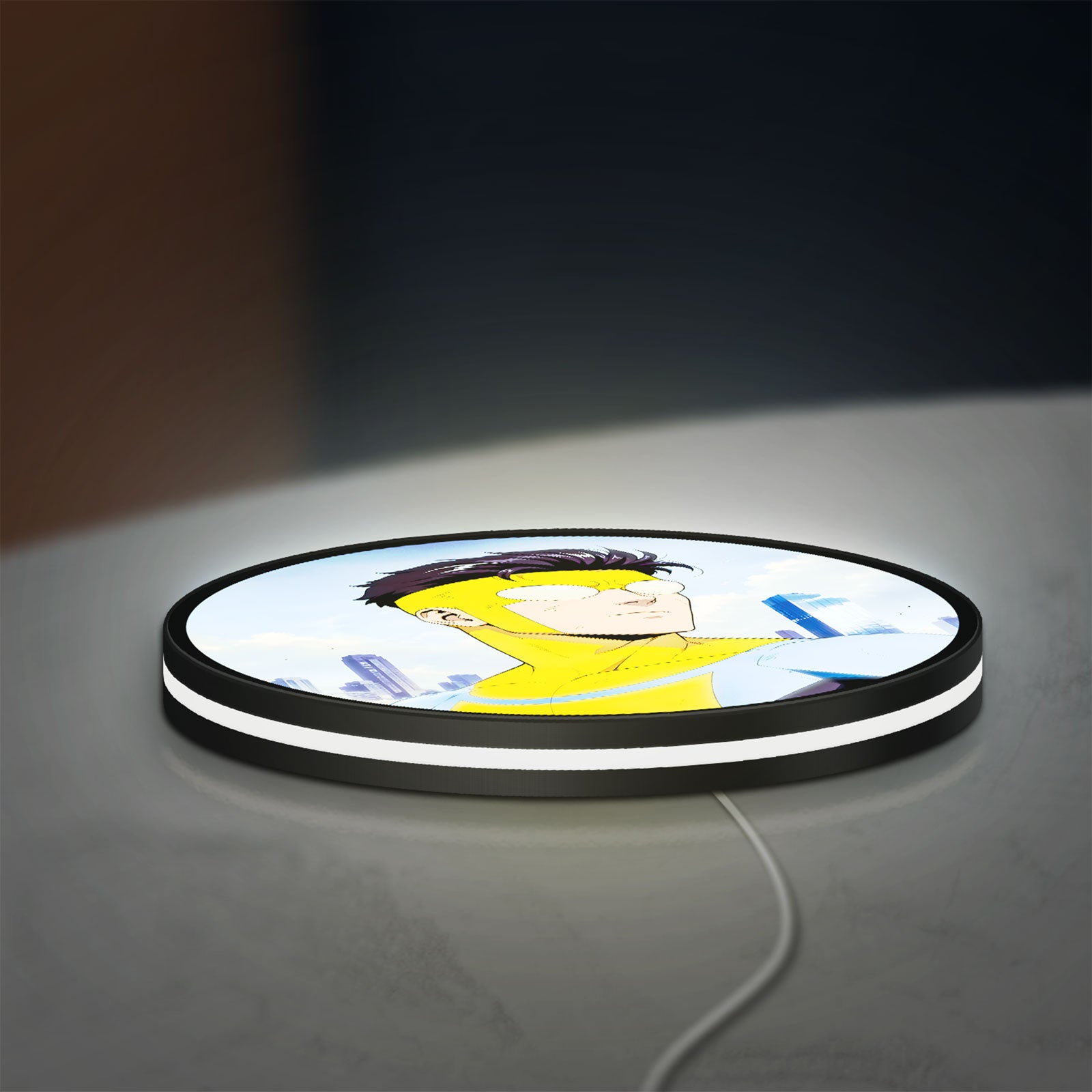 Invincible Title Logo Superhero LED lightbox lying flat on a desk with white glow