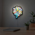 Invincible Title Logo Superhero LED lightbox hanging on a room wall with soft white light