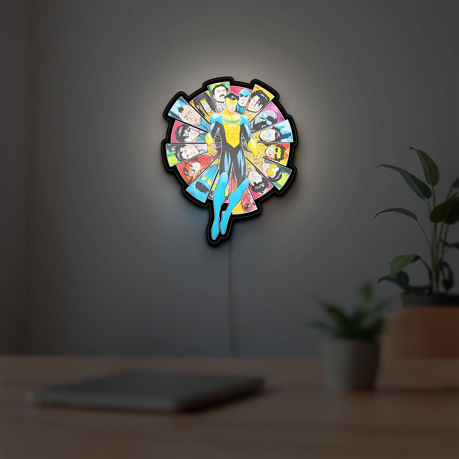 Invincible Title Logo Superhero LED lightbox hanging on a room wall with soft white light