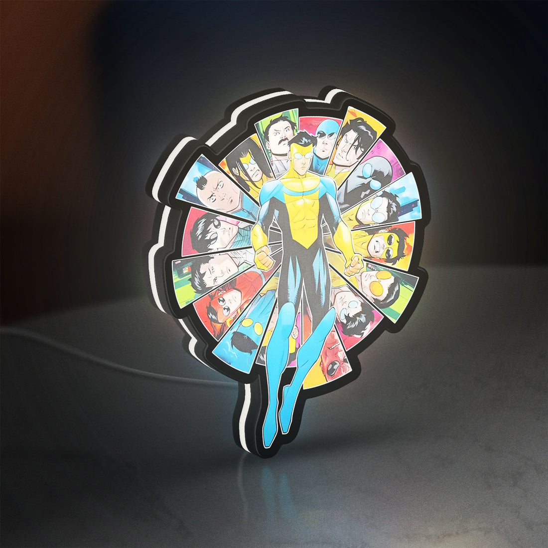 Invincible Title Logo Superhero LED lightbox hanging on a wall with white glow