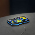 Invincible Title Logo Superhero LED lightbox lying flat on a desk with blue glow