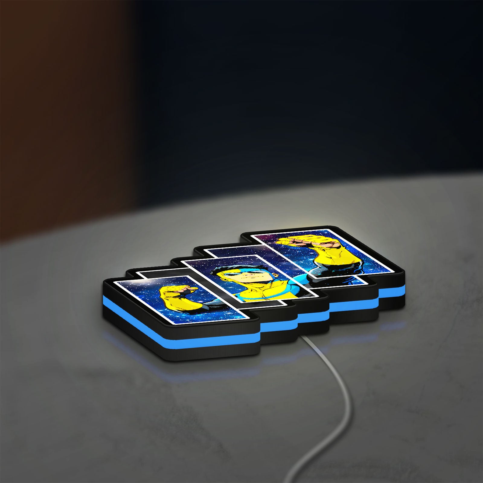 Invincible Title Logo Superhero LED lightbox lying flat on a desk with blue glow
