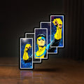 Front view of Invincible Title Logo Superhero LED lightbox sign glowing on a wooden desk