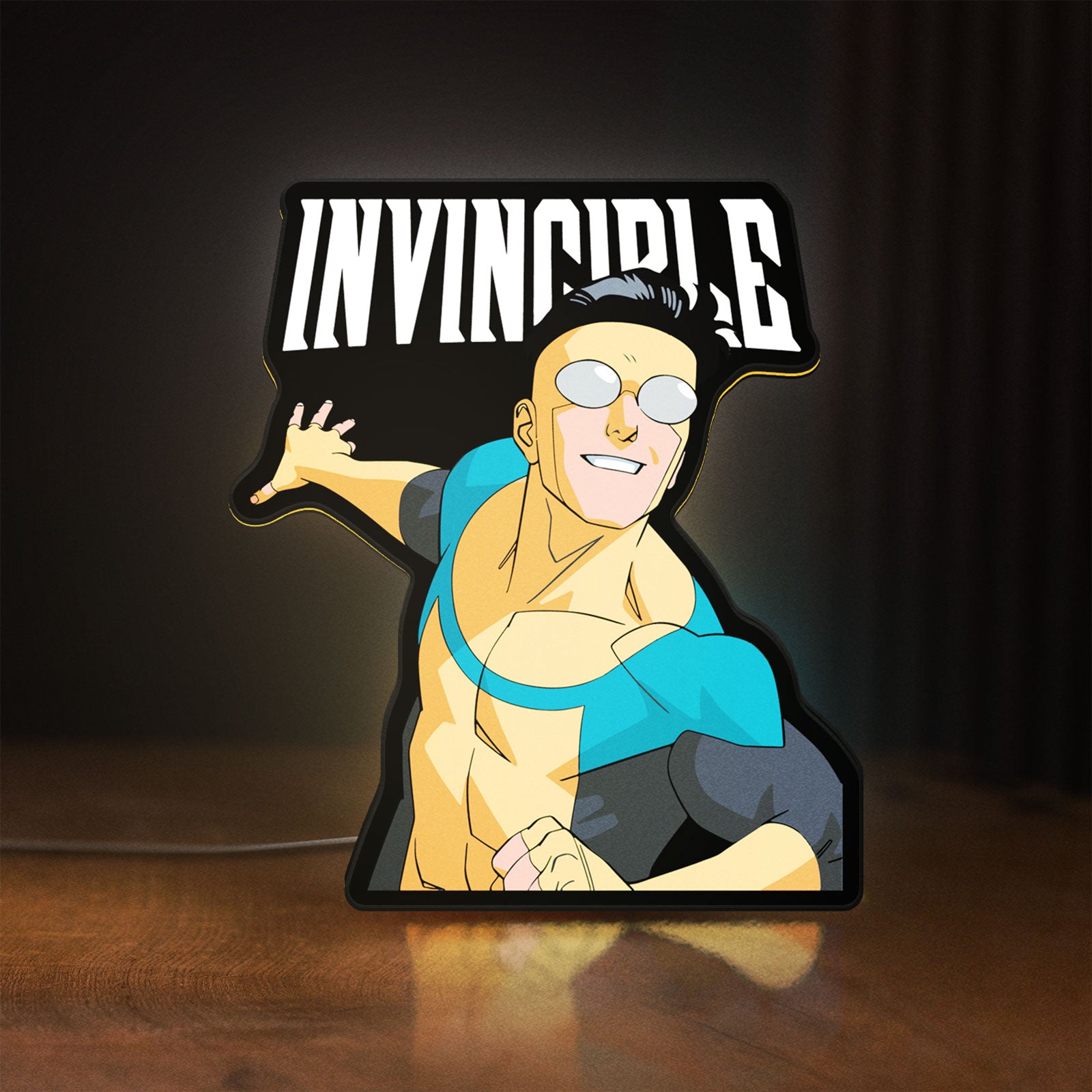 Front view of Invincible Think Mark Think Meme LED lightbox sign glowing on a wooden desk