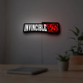 Invincible V Logo Mark Grayson LED lightbox hanging on a room wall with soft white light