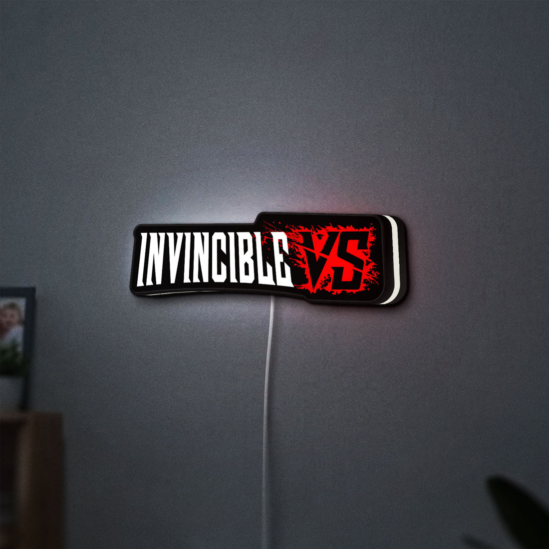Invincible V Logo Mark Grayson LED lightbox hanging on a wall with white glow