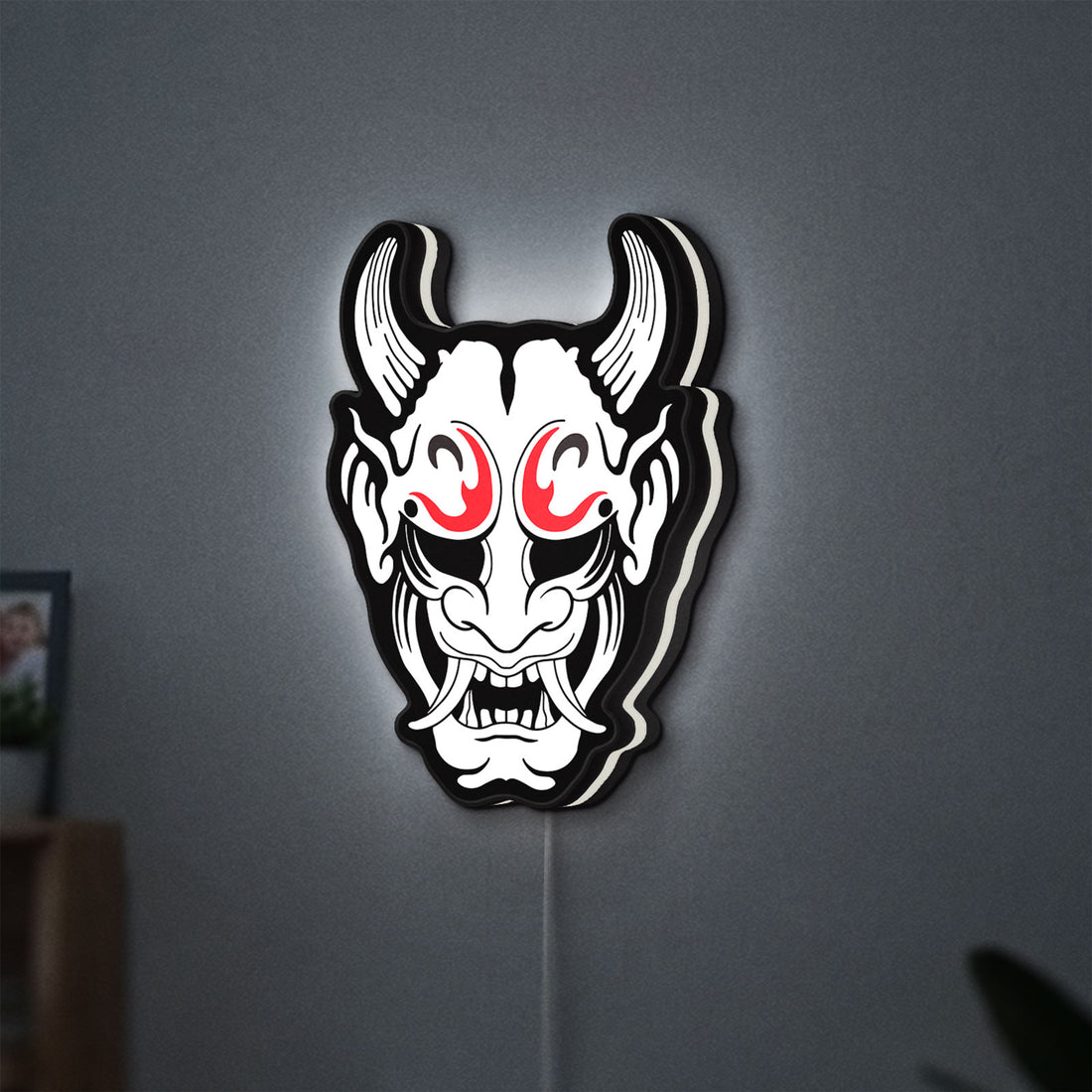 Cyberpunk Japanese Oni Mask Demon LED lightbox hanging on a wall with white glow
