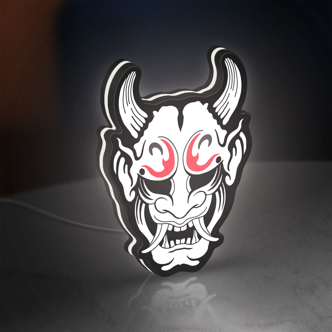 Cyberpunk Japanese Oni Mask Demon LED lightbox hanging on a wall with white glow