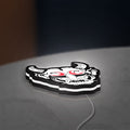 Cyberpunk Japanese Oni Mask Demon LED lightbox lying flat on a desk with white glow