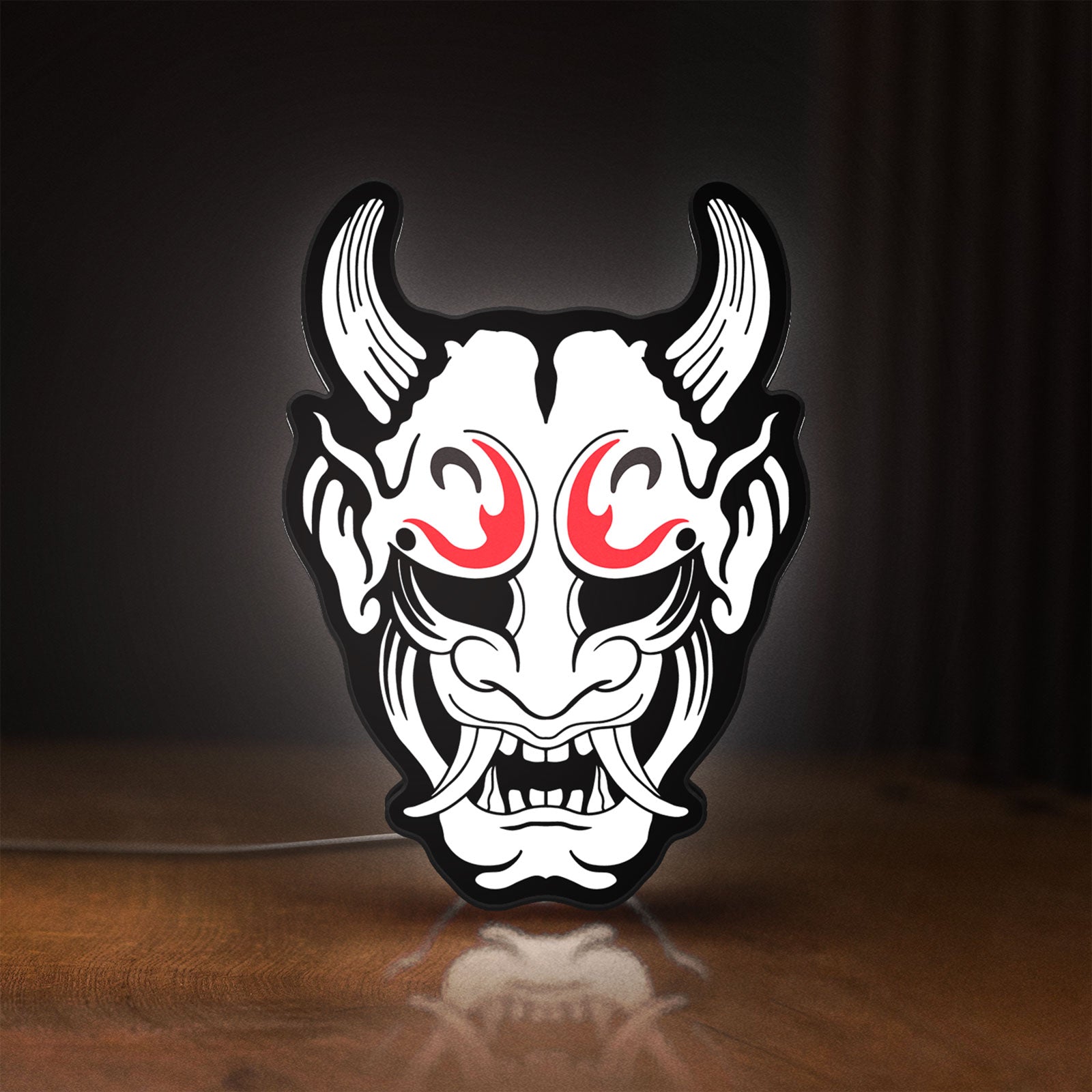 Front view of Cyberpunk Japanese Oni Mask Demon LED lightbox sign glowing on a wooden desk