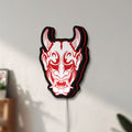Unlit Cyberpunk Japanese Oni Mask Demon LED lightbox mounted on a wall in daylight