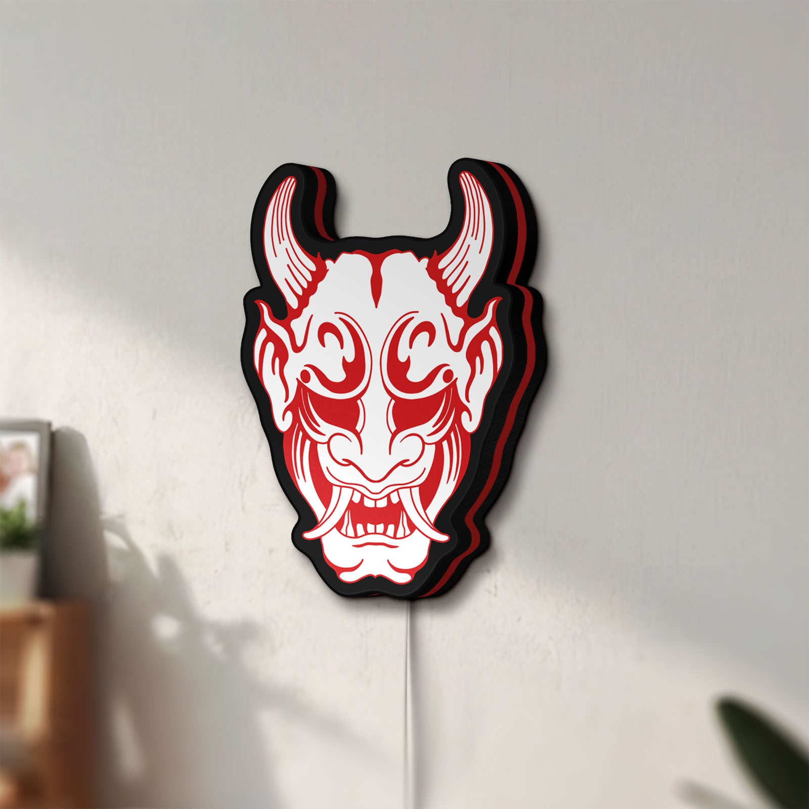 Unlit Cyberpunk Japanese Oni Mask Demon LED lightbox mounted on a wall in daylight