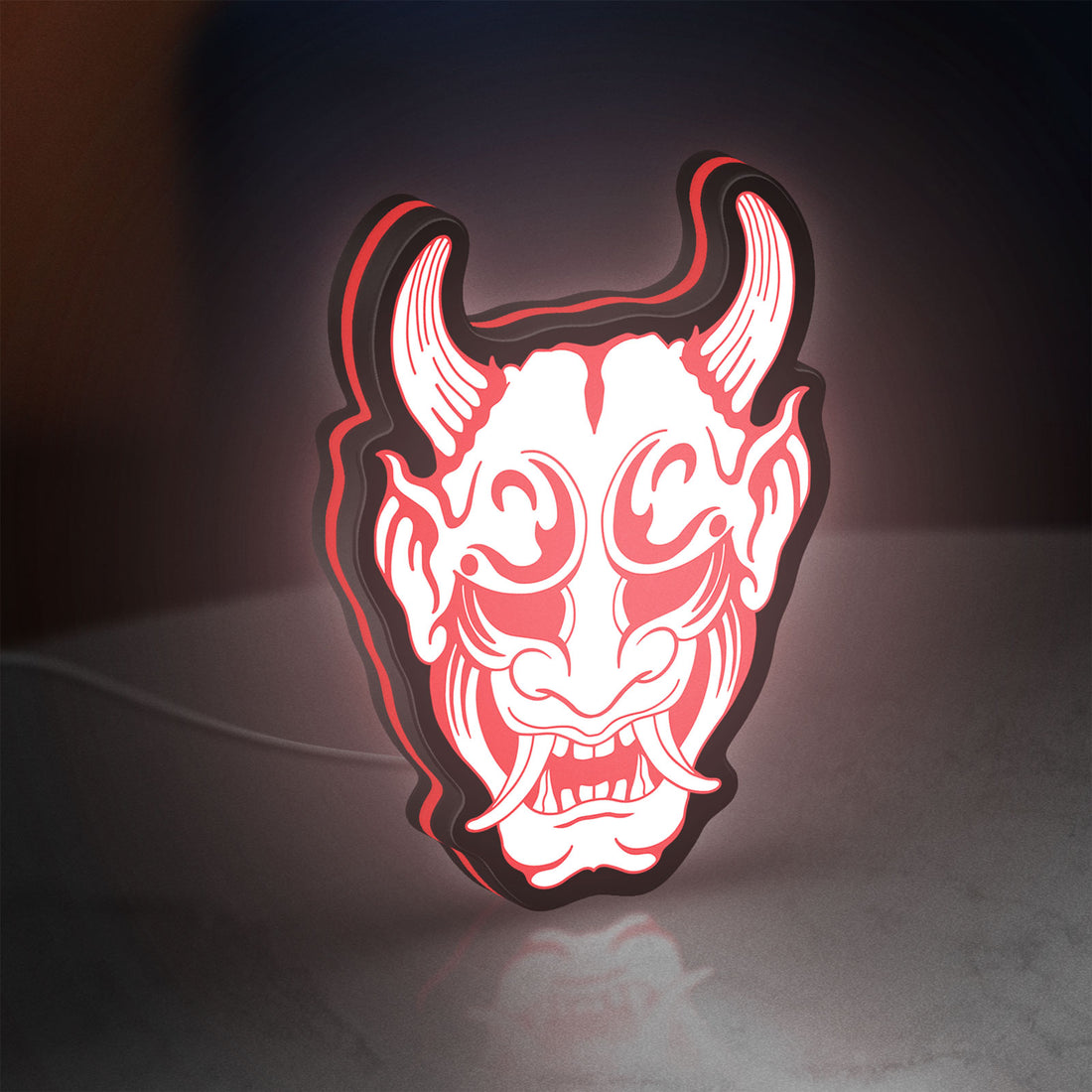 Cyberpunk Japanese Oni Mask Demon LED lightbox hanging on a wall with red glow