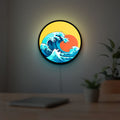 Great Wave off Kanagawa Ocean Art LED lightbox hanging on a room wall with soft yellow light