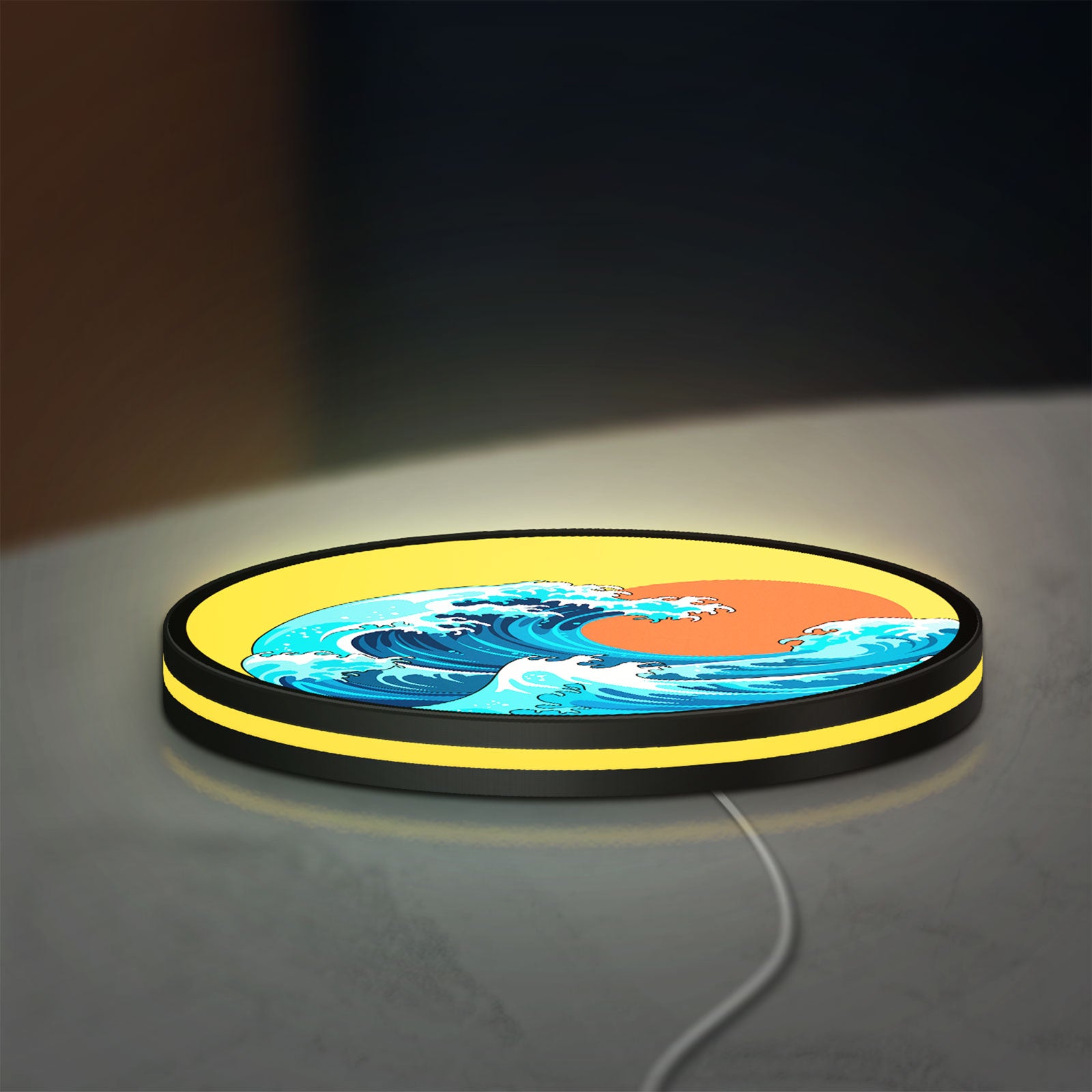 Great Wave off Kanagawa Ocean Art LED lightbox lying flat on a desk with yellow glow