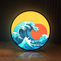 Front view of Great Wave off Kanagawa Ocean Art LED lightbox sign glowing on a wooden desk