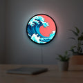 Great Wave off Kanagawa Ocean Art LED lightbox hanging on a room wall with soft red light