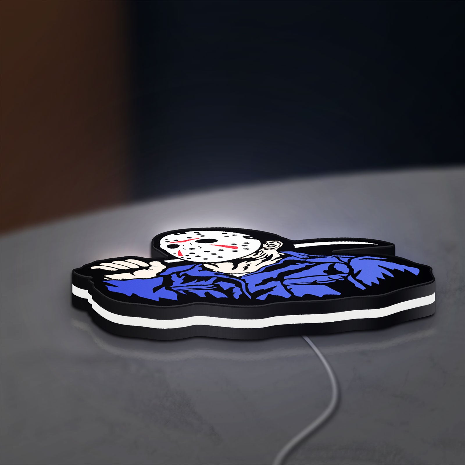 Friday the 13th Jason Mask Slasher LED lightbox lying flat on a desk with white glow