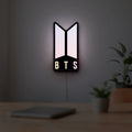 BTS ARMY Logo K-Pop Idol Music Fan LED lightbox hanging on a room wall with soft pink light