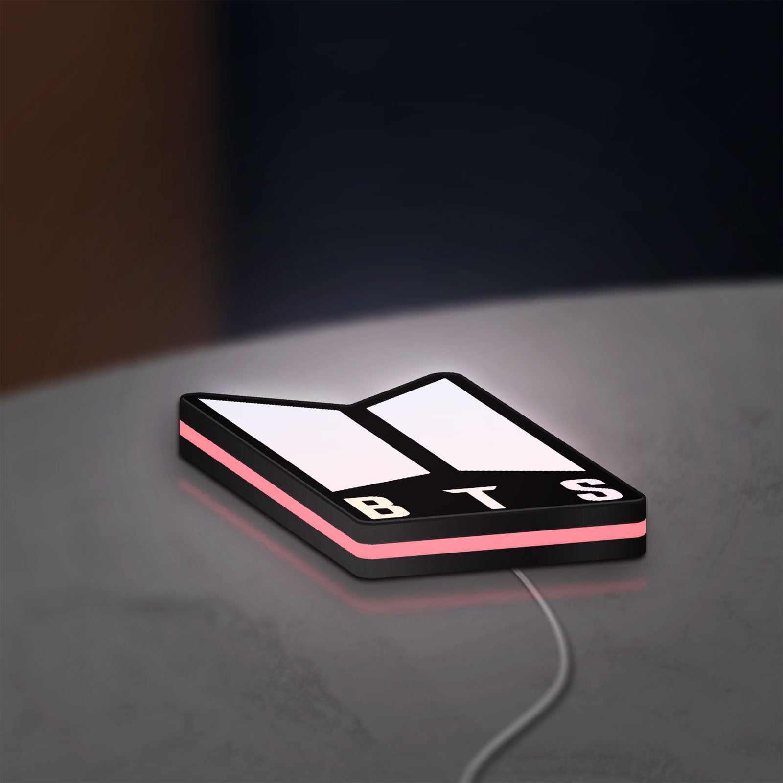 BTS ARMY Logo K-Pop Idol Music Fan LED lightbox lying flat on a desk with pink glow